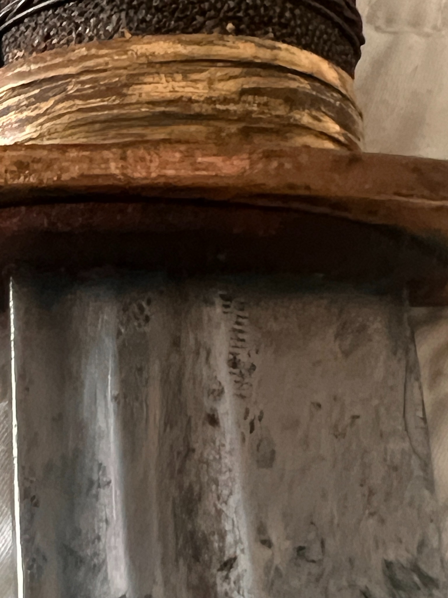 Macro photograph of the blade near the guard showing fullers and engraved ornament
