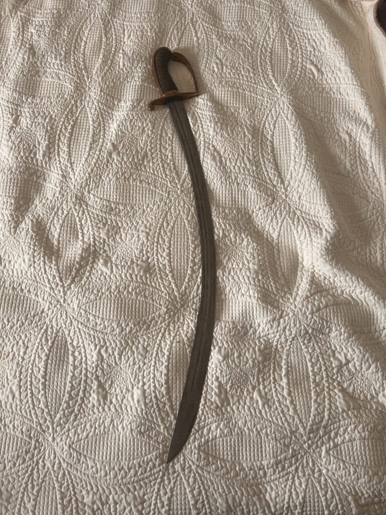 Detailed view of the saber blade fuller, edge, spine and engraved surface